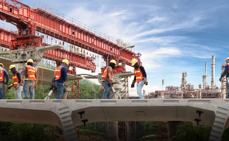 Construction crew placing TMT-reinforced steelwork on a large infrastructure project