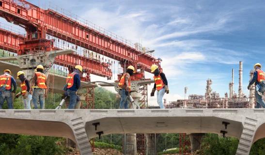 Workers assembling steel reinforcement on an Indian infrastructure site