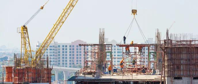 Metro viaduct under construction with tower cranes